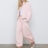 Pantaloni sarouel con pinces e fibbia